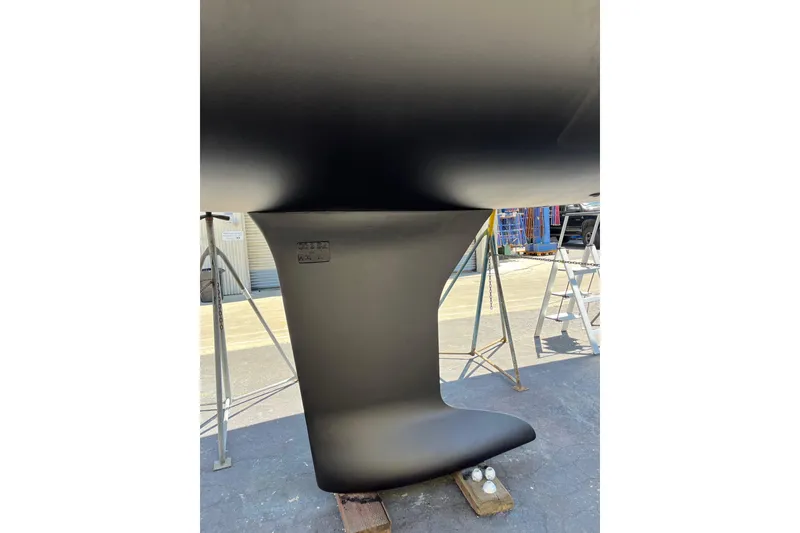 Slide: The Image of 2021 Beneteau Oceanis 30.1 keel in dry dock, showcasing sleek design and craftsmanship. - 17