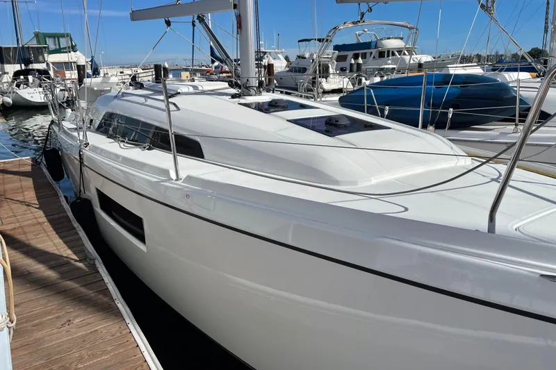 Slide: The Image of 2021 Beneteau Oceanis 30.1 yacht docked at marina under clear blue sky. - 2