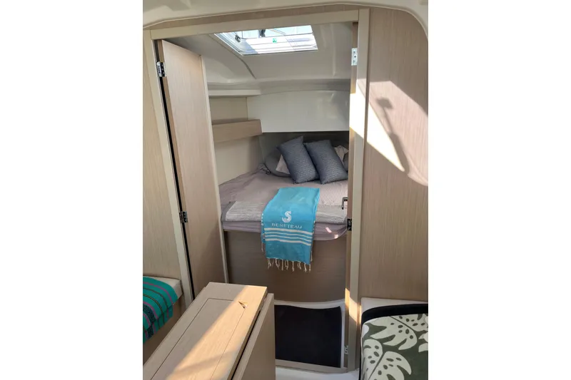 Slide: The Image of Cozy cabin interior of 2021 Beneteau Oceanis 30.1 sailboat with bed and skylight. - 24