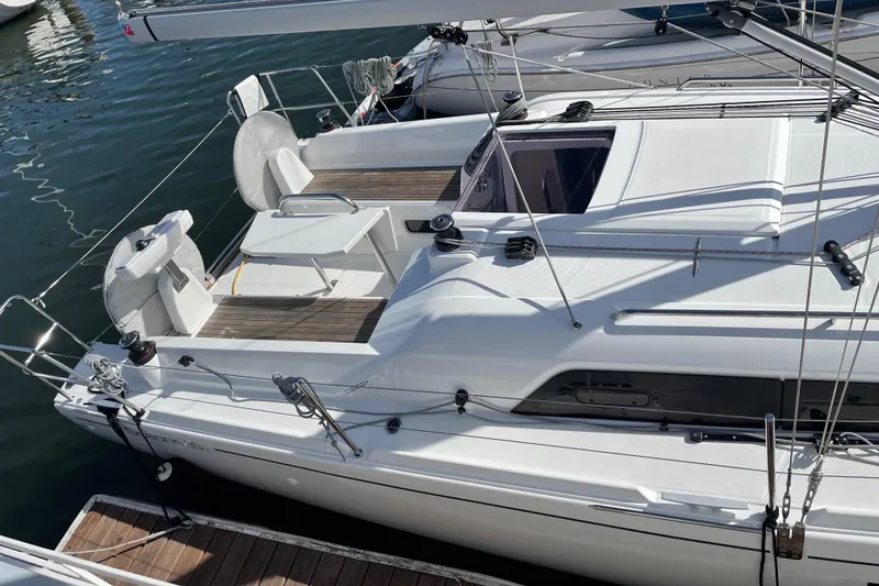 Slide: The Image of 2021 Beneteau Oceanis 30.1 sailboat docked, showcasing sleek deck design and modern features. - 3