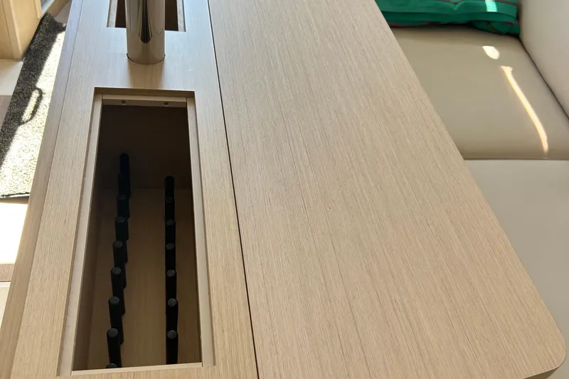 Slide: The Image of Interior view of 2021 Beneteau Oceanis 30.1 yacht with wooden table and seating. - 33