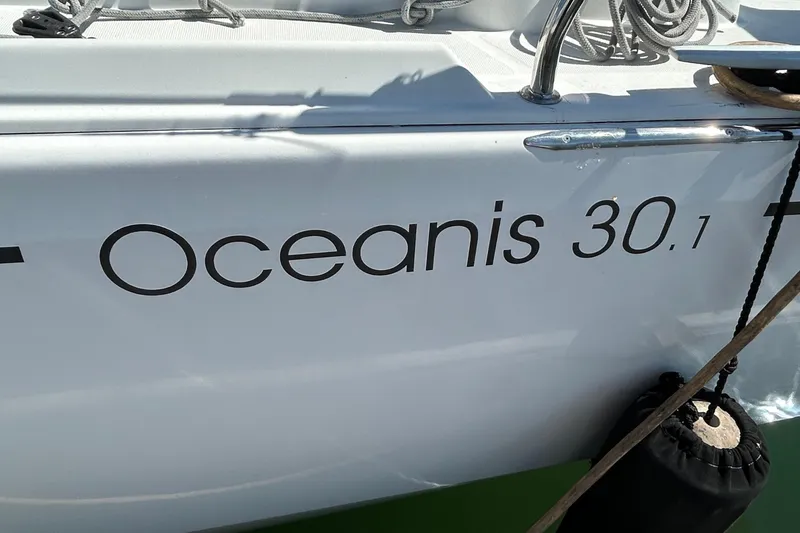 Slide: The Image of 2021 Beneteau Oceanis 30.1 sailboat with visible name and dock ropes. - 4