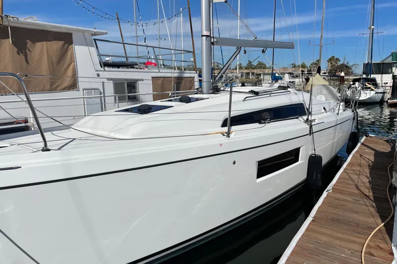 Slide: The Image of 2021 Beneteau Oceanis 30.1 sailboat docked at marina under clear blue sky. - 5