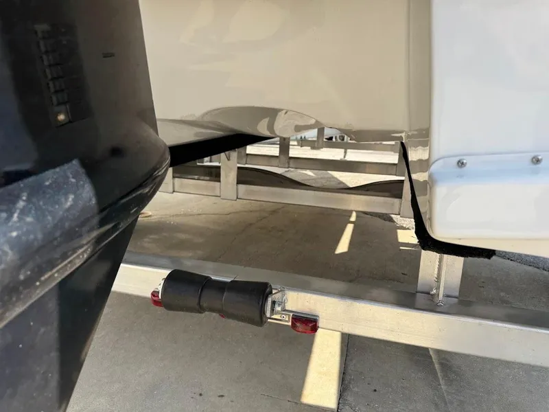 Slide: The Image of 2025 Shallow Sport 18 Sport boat on trailer, close-up view of hull and support. - 11