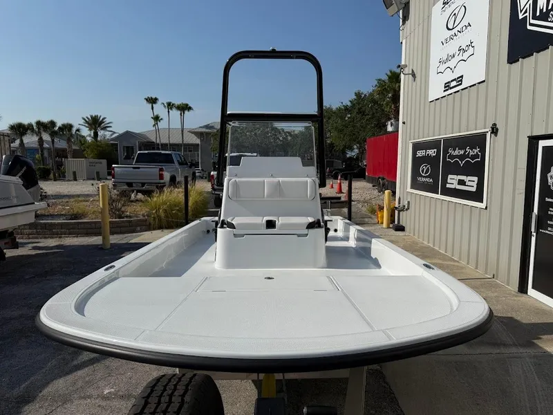 Slide: The Image of 2025 Shallow Sport 18 Sport boat displayed outdoors at a dealership. - 3