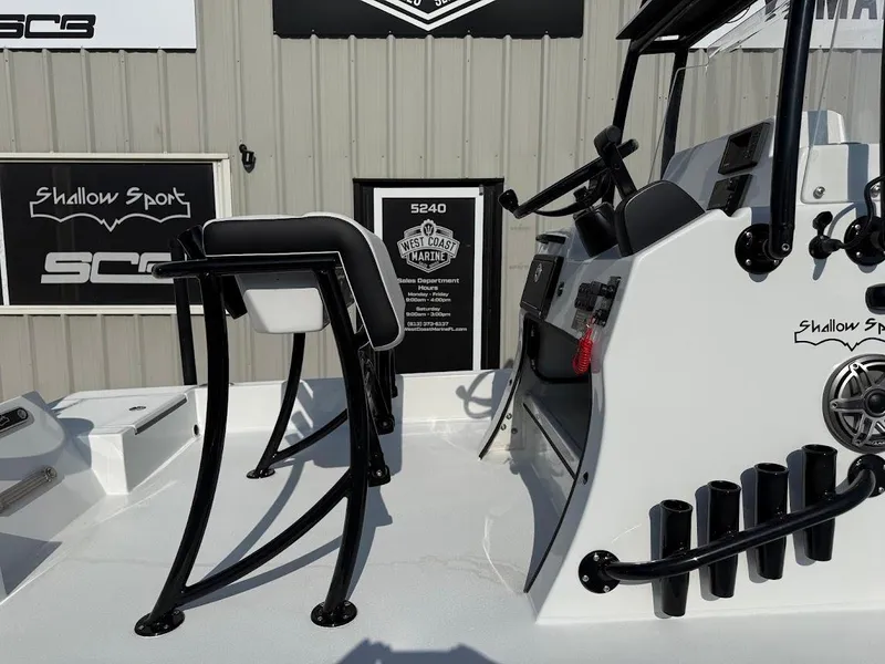 Slide: The Image of 2025 Shallow Sport 18 Sport boat interior with console and seating, displayed at West Coast Marine. - 8