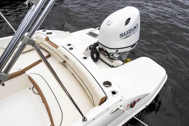 Slide: The Image of Manufacturer Provided Image: 2024 Stingray 182 SC boat with Suzuki outboard motor on water. - 12