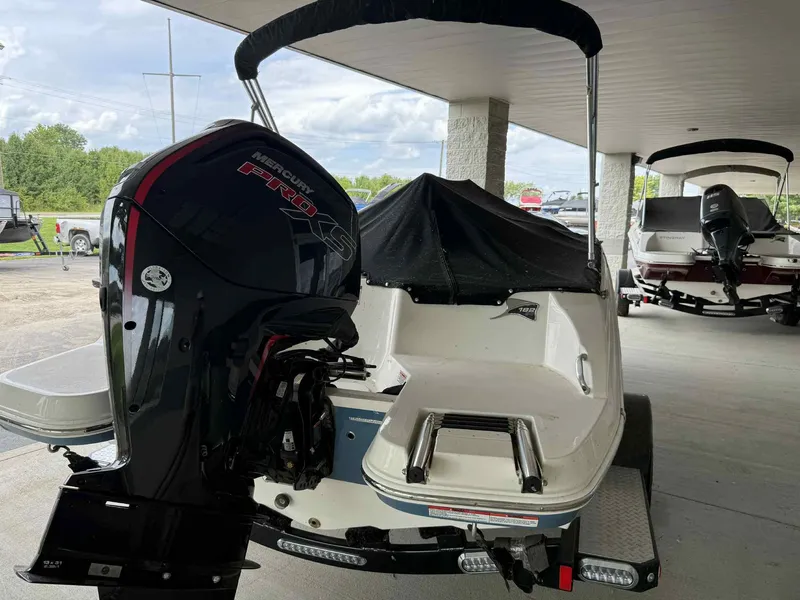 Slide: The Image of 2024 Stingray 182 SC boat with Mercury Pro XS engine, parked under a canopy. - 4
