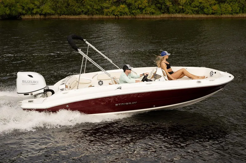 Slide: The Image of Manufacturer Provided Image: 2024 Stingray 182 SC boat cruising on a lake with two passengers. - 5