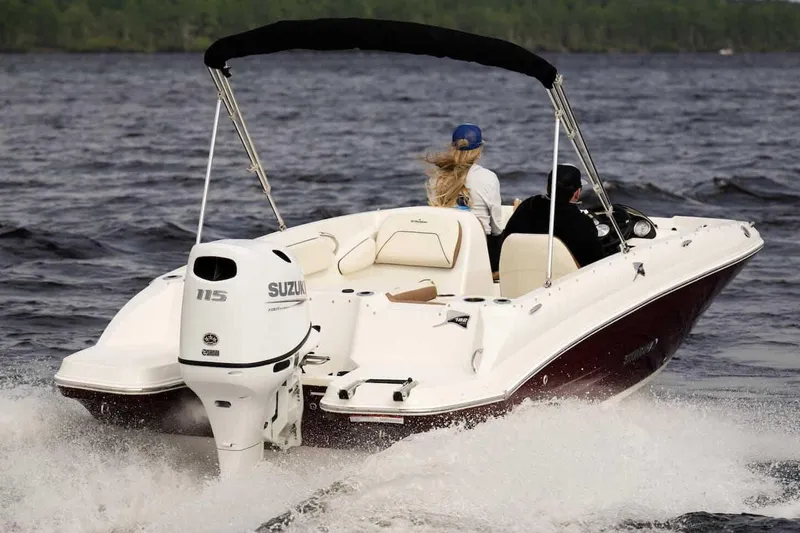 Slide: The Image of Manufacturer Provided Image: 2024 Stingray 182 SC boat cruising on a lake with Suzuki outboard motor. - 6