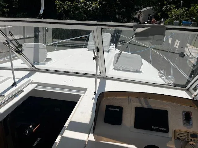 Slide: The Image of 2003 Mainship Pilot 34 boat cockpit with navigation equipment and windshield. - 12