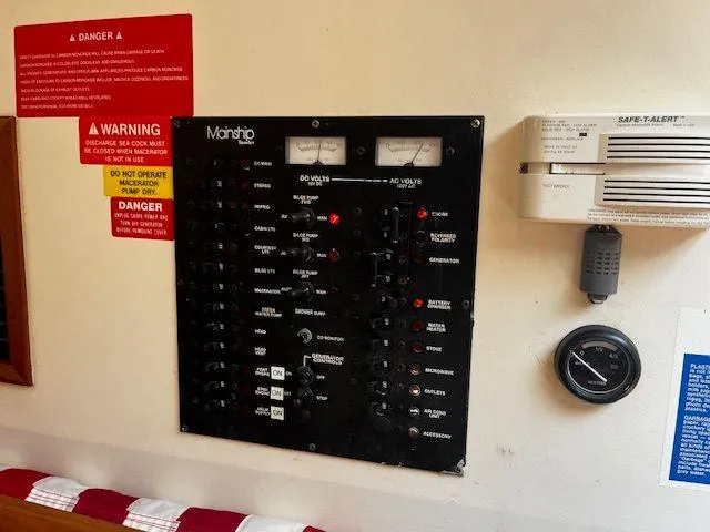 Slide: The Image of Electrical control panel on a 2003 Mainship Pilot 34 boat with safety warnings. - 20