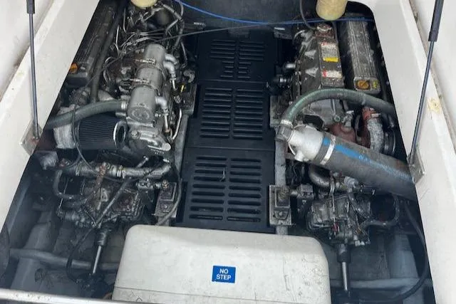 Slide: The Image of Engine compartment of a 2003 Mainship Pilot 34 boat, showing dual engines and mechanical components. - 21