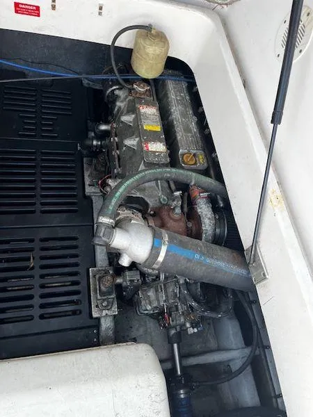 Slide: The Image of Engine compartment of a 2003 Mainship Pilot 34 boat, showing mechanical components. - 22