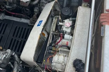 Slide: The Image of Engine compartment of a 2003 Mainship Pilot 34 boat, showing mechanical components. - 24