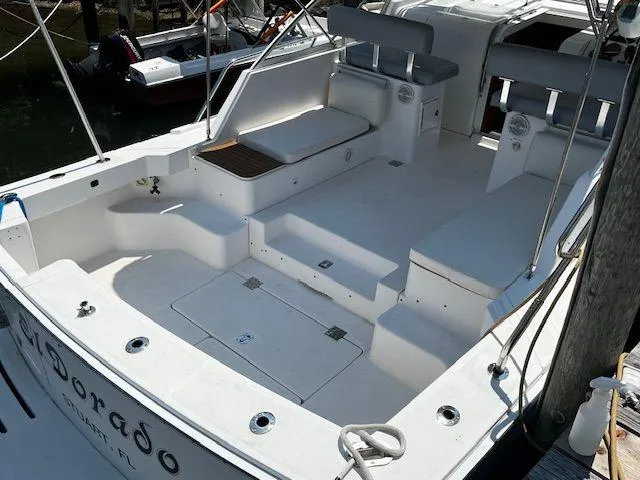 Slide: The Image of 2003 Mainship Pilot 34 boat deck with seating and storage compartments. - 6