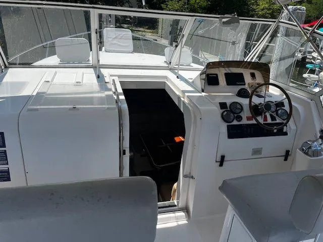 Slide: The Image of 2003 Mainship Pilot 34 boat cockpit with steering wheel and control panel. - 8