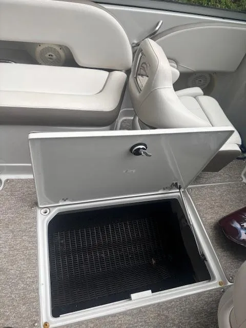 Slide: The Image of 2018 Crownline Eclipse E215 XS boat interior with open storage compartment. - 10
