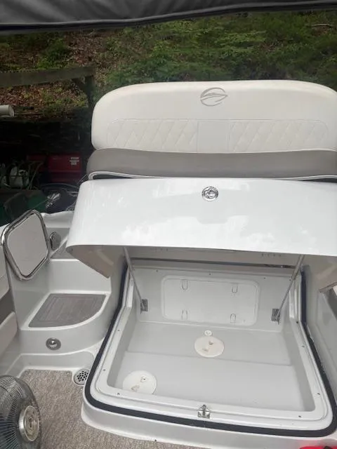 Slide: The Image of 2018 Crownline Eclipse E215 XS boat with open storage compartment. - 11