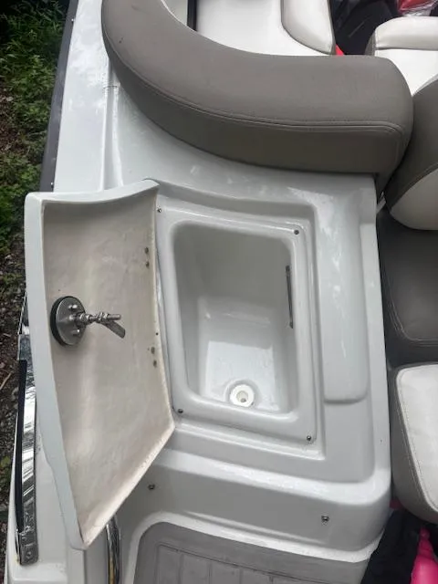 Slide: The Image of 2018 Crownline Eclipse E215 XS boat with open storage compartment and seating area. - 12