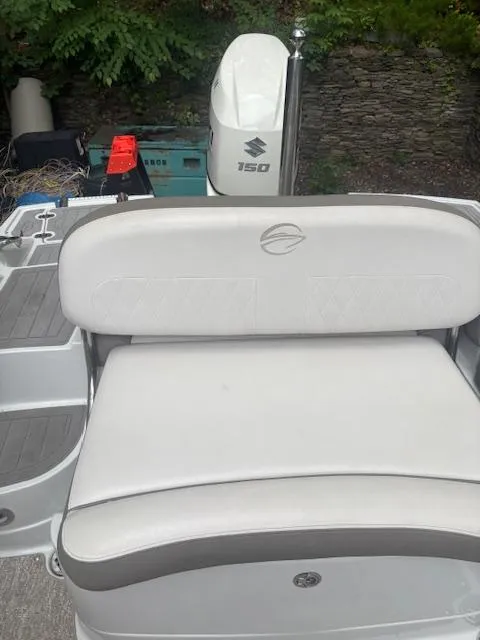 Slide: The Image of 2018 Crownline Eclipse E215 XS boat with Suzuki 150 engine, featuring white seating. - 13
