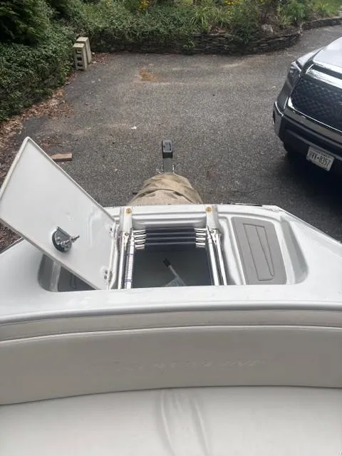 Slide: The Image of 2018 Crownline Eclipse E215 XS boat with open storage compartment and ladder. - 16