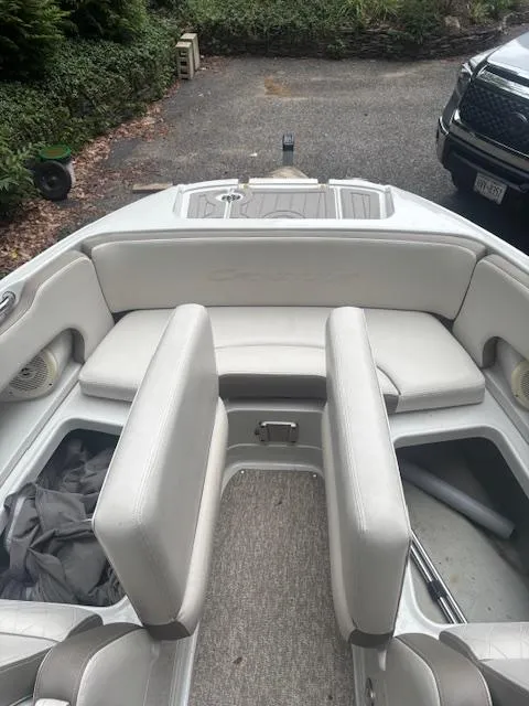 Slide: The Image of 2018 Crownline Eclipse E215 XS boat interior with cushioned seating and storage compartments. - 19