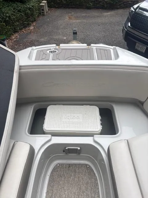 Slide: The Image of 2018 Crownline Eclipse E215 XS boat interior with Igloo cooler in storage compartment. - 20