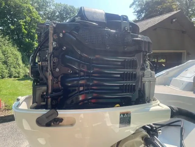 Slide: The Image of 2018 Crownline Eclipse E215 XS boat engine in a sunny outdoor setting. - 24
