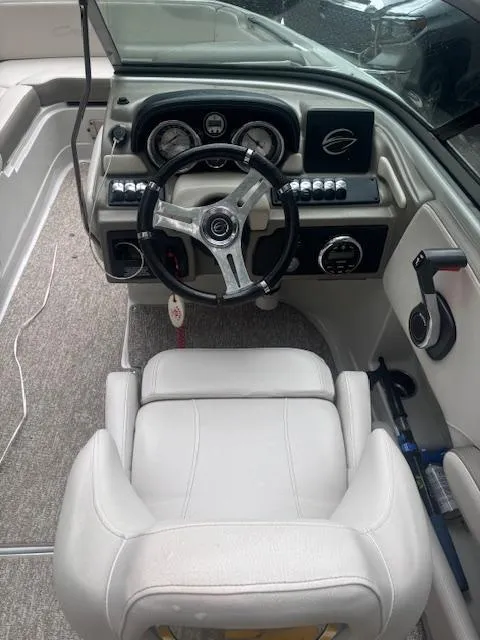 Slide: The Image of 2018 Crownline Eclipse E215 XS boat cockpit with steering wheel and dashboard controls. - 6