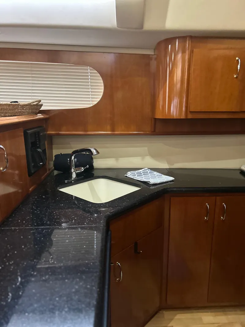 Slide: The Image of Luxurious kitchen in 2003 Carver 466 Motor Yacht with modern appliances and elegant wood cabinetry. - 14