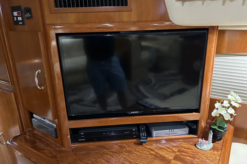 Slide: The Image of Interior of 2003 Carver 466 Motor Yacht with wood finishes and cozy seating area. - 16