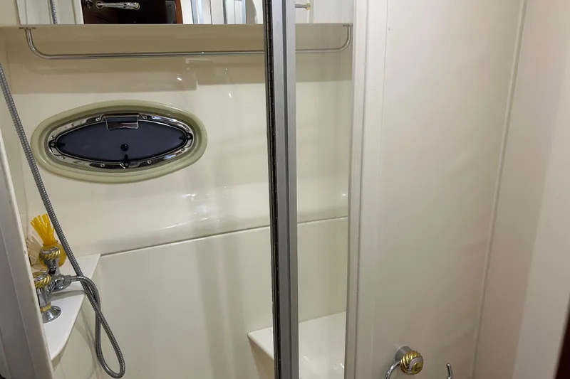 Slide: The Image of Shower area in 2003 Carver 466 Motor Yacht with oval window and chrome fixtures. - 21
