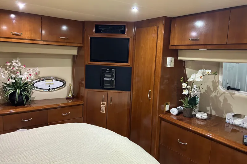 Slide: The Image of Luxurious kitchen interior of 2003 Carver 466 Motor Yacht with wood cabinetry and modern appliances. - 24