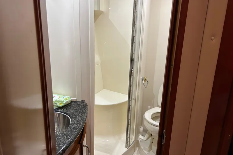 Slide: The Image of Engine room of a 2003 Carver 466 Motor Yacht, showcasing detailed mechanical components. - 32