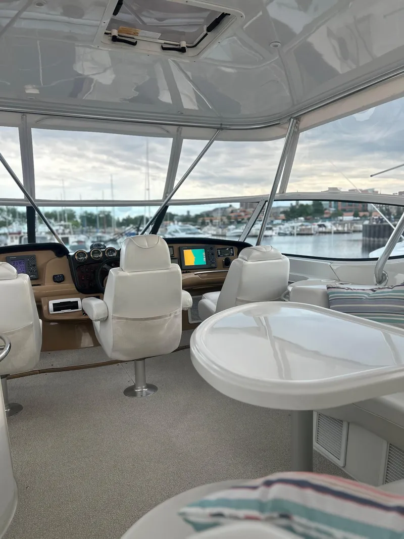 Slide: The Image of 2003 Carver 466 Motor Yacht docked in a marina under clear blue skies. - 4