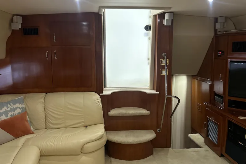 Slide: The Image of Interior of 2003 Carver 466 Motor Yacht bedroom with wooden cabinetry and cozy bedding. - 53