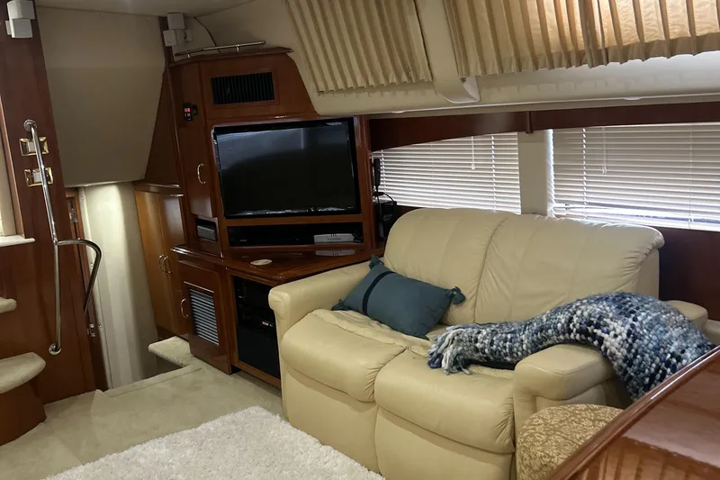 Slide: The Image of Interior of 2003 Carver 466 Motor Yacht with wooden cabinetry and window blinds. - 54