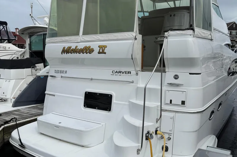 Slide: The Image of 2003 Carver 466 Motor Yacht docked, featuring "Michelle IV" name on the stern. - 91