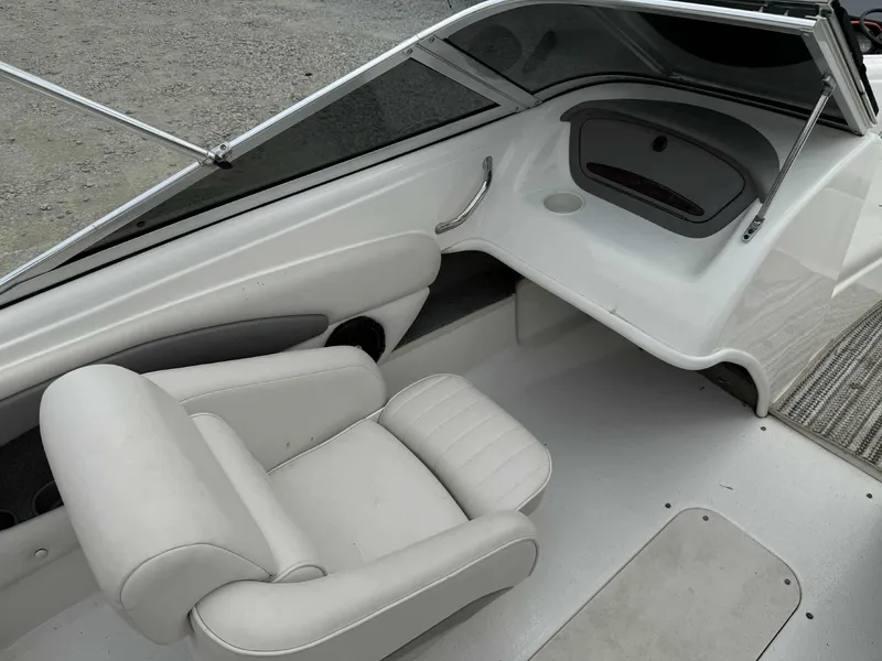 Slide: The Image of 2007 Chaparral 180 SSi boat interior with white seating and dashboard. - 10