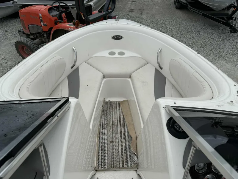 Slide: The Image of 2007 Chaparral 180 SSi boat interior with white seating and striped carpet. - 6