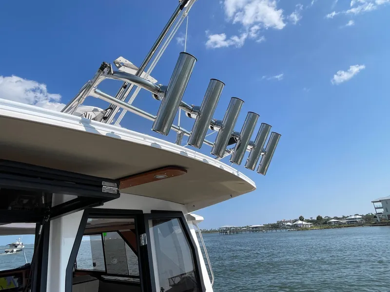 Slide: The Image of 2026 Cutwater C-288 Coupe boat with rod holders, docked on a sunny day. - 10