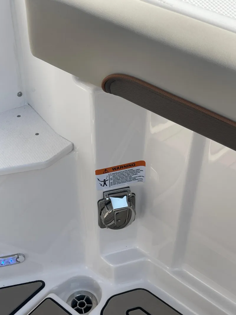 Slide: The Image of 2026 Cutwater C-288 Coupe boat interior detail with warning label and latch. - 15
