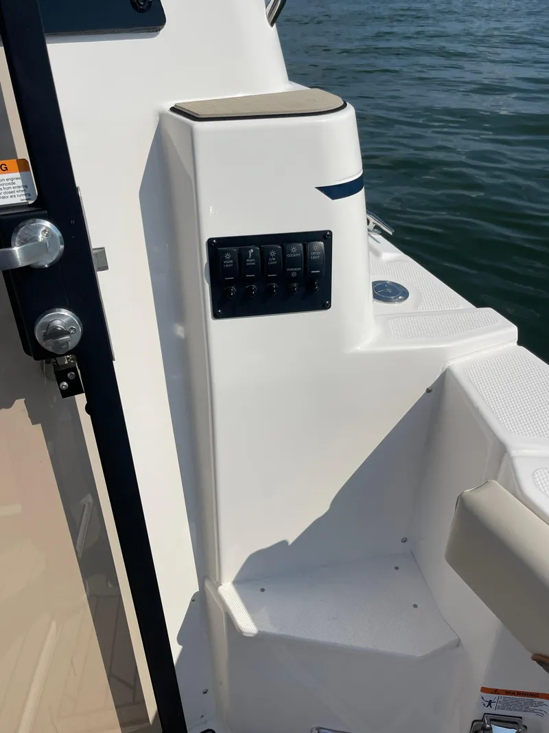 Slide: The Image of 2026 Cutwater C-288 Coupe boat interior with control panel, near water. - 16