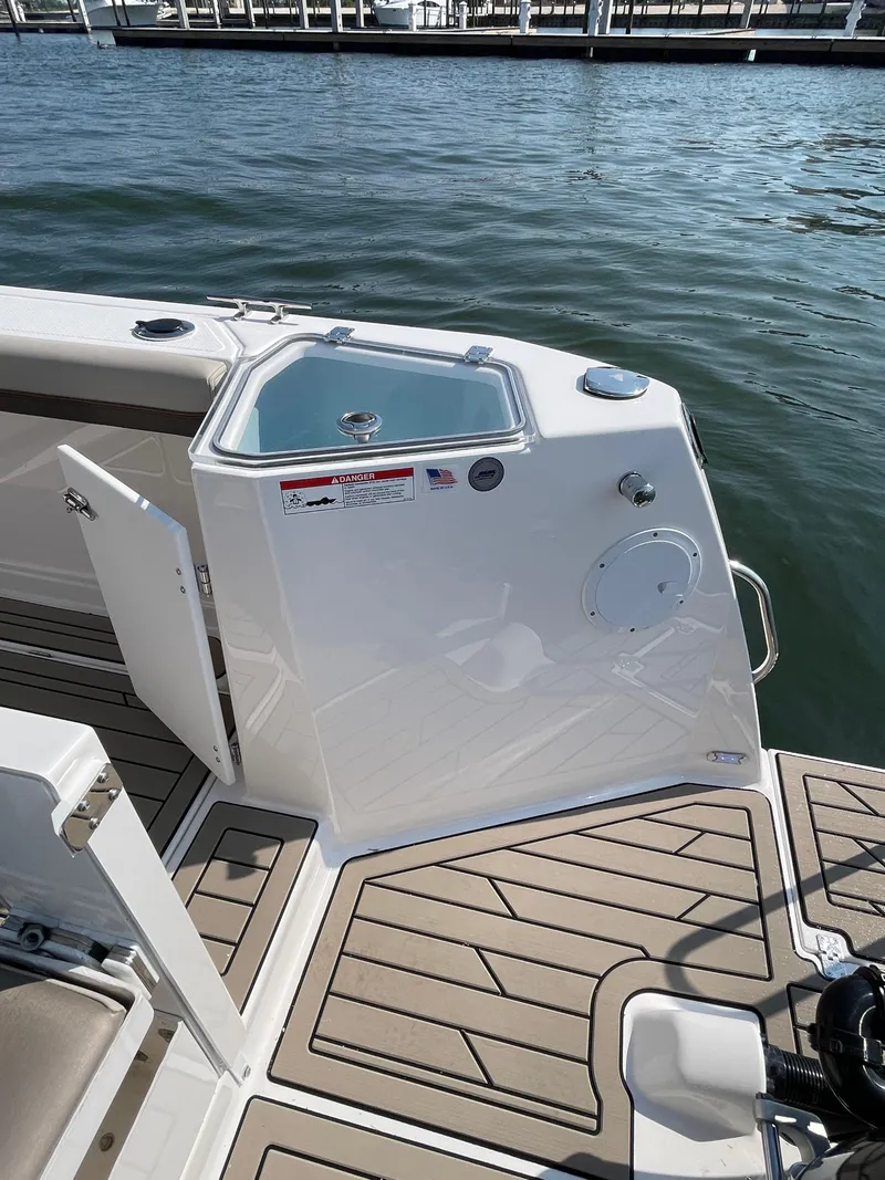 Slide: The Image of 2026 Cutwater C-288 Coupe boat deck with storage compartment and water view. - 18