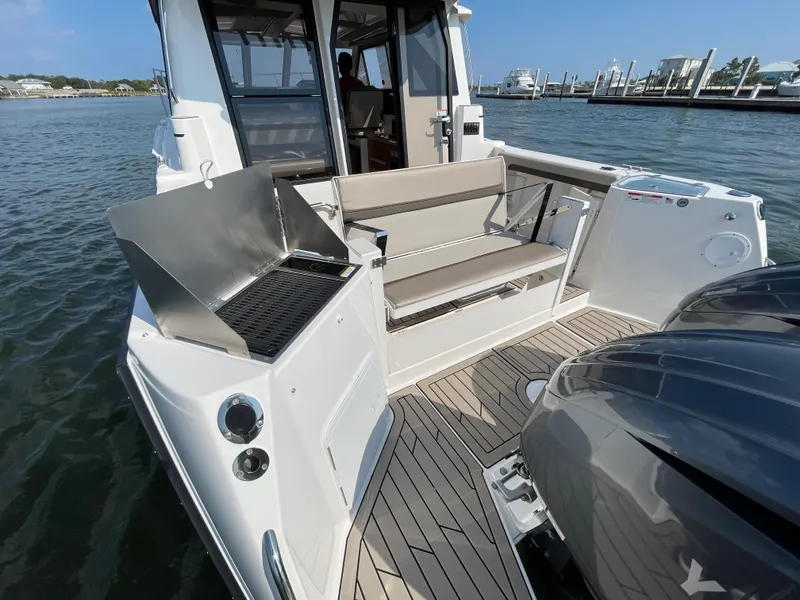 Slide: The Image of 2026 Cutwater C-288 Coupe boat with outdoor seating and grill on deck. - 20