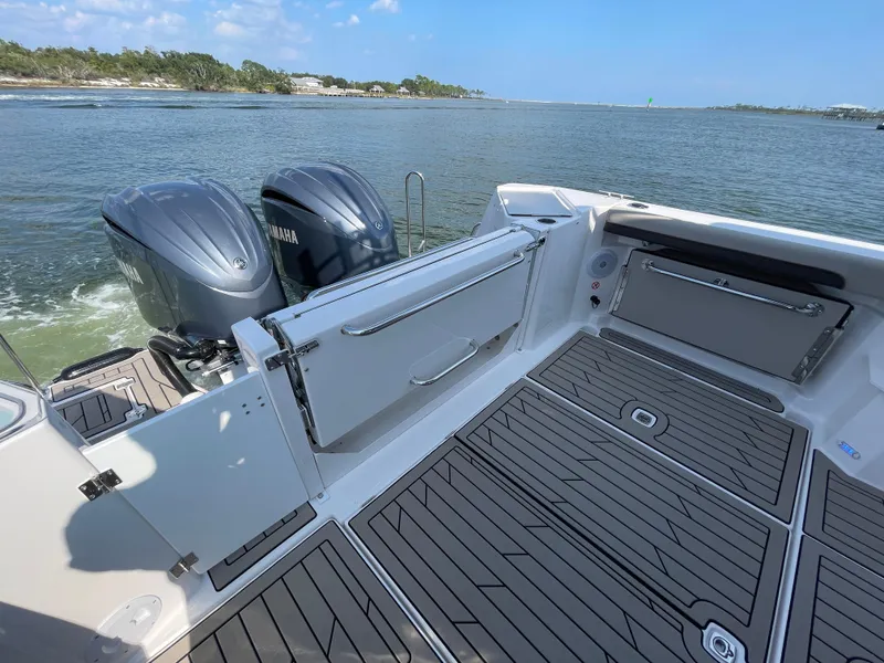 Slide: The Image of 2026 Cutwater C-288 Coupe boat with Yamaha engines on a calm waterway. - 26