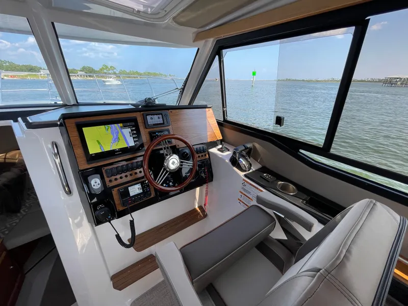 Slide: The Image of Interior of 2026 Cutwater C-288 Coupe boat with modern navigation system and steering wheel. - 31