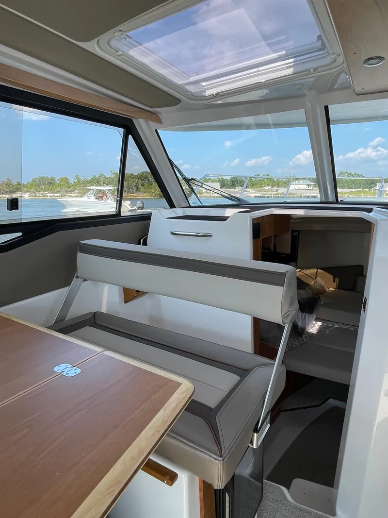 Slide: The Image of Interior of 2026 Cutwater C-288 Coupe boat with seating and table, under a skylight. - 33