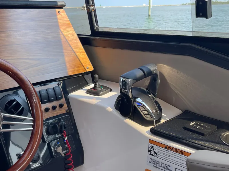 Slide: The Image of Interior of 2026 Cutwater C-288 Coupe boat, featuring steering controls and dashboard. - 35